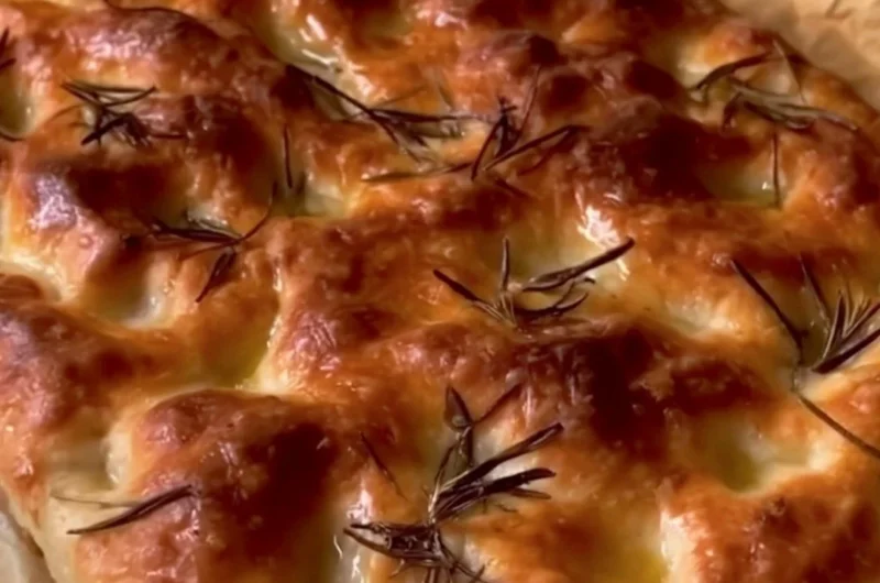 Freshly baked sourdough focaccia with herbs and olive oil