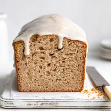 Deliciously moist apple spice cake with cinnamon and nutmeg in a cozy setting.