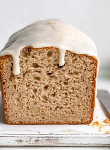 Deliciously moist apple spice cake with cinnamon and nutmeg in a cozy setting.